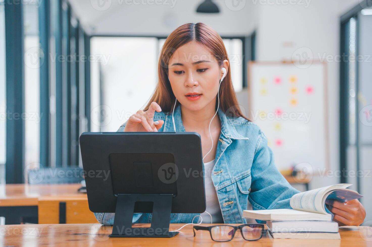 young student wearing small talk studies online, distance learning, and keeps up to date on the global coronavirus pandemic photo