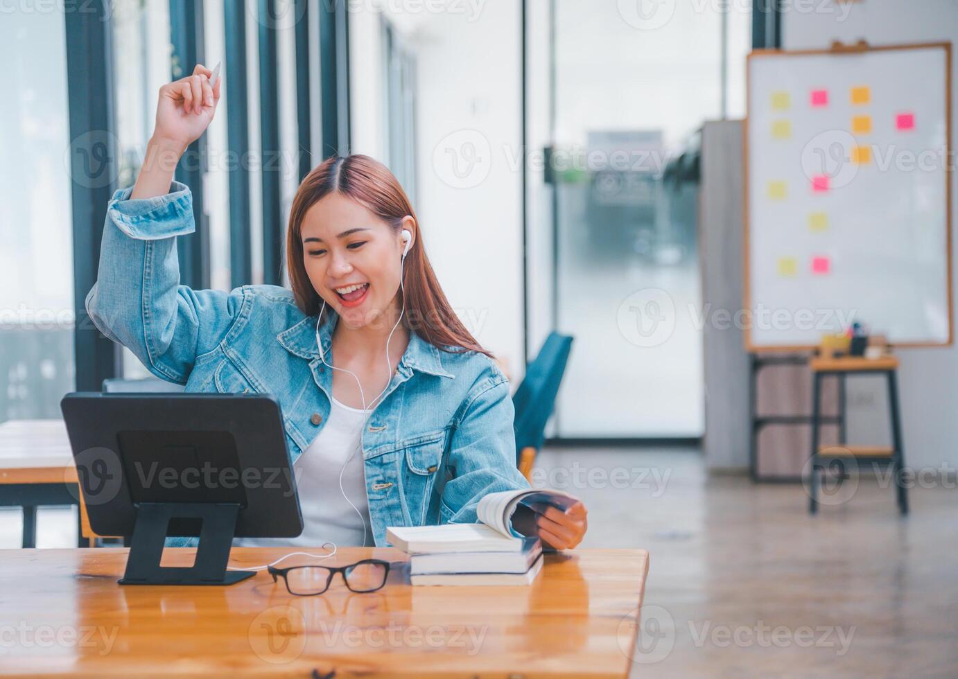 young student wearing small talk studies online, distance learning, and keeps up to date on the global coronavirus pandemic photo