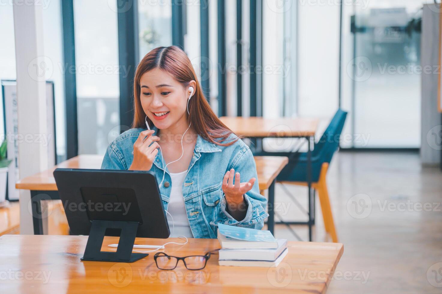 young student wearing small talk studies online, distance learning, and keeps up to date on the global coronavirus pandemic photo