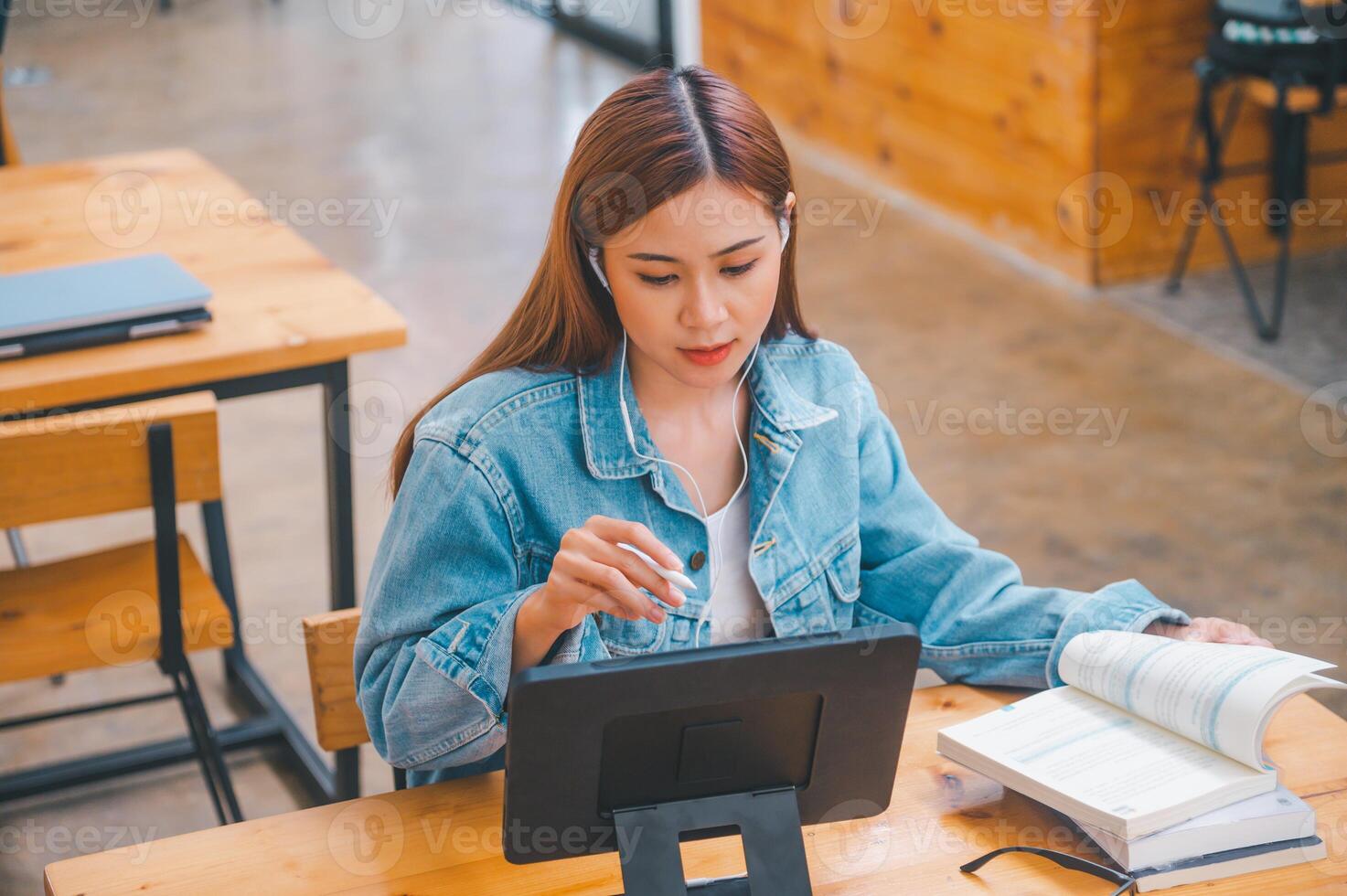 young student wearing small talk studies online, distance learning, and keeps up to date on the global coronavirus pandemic photo