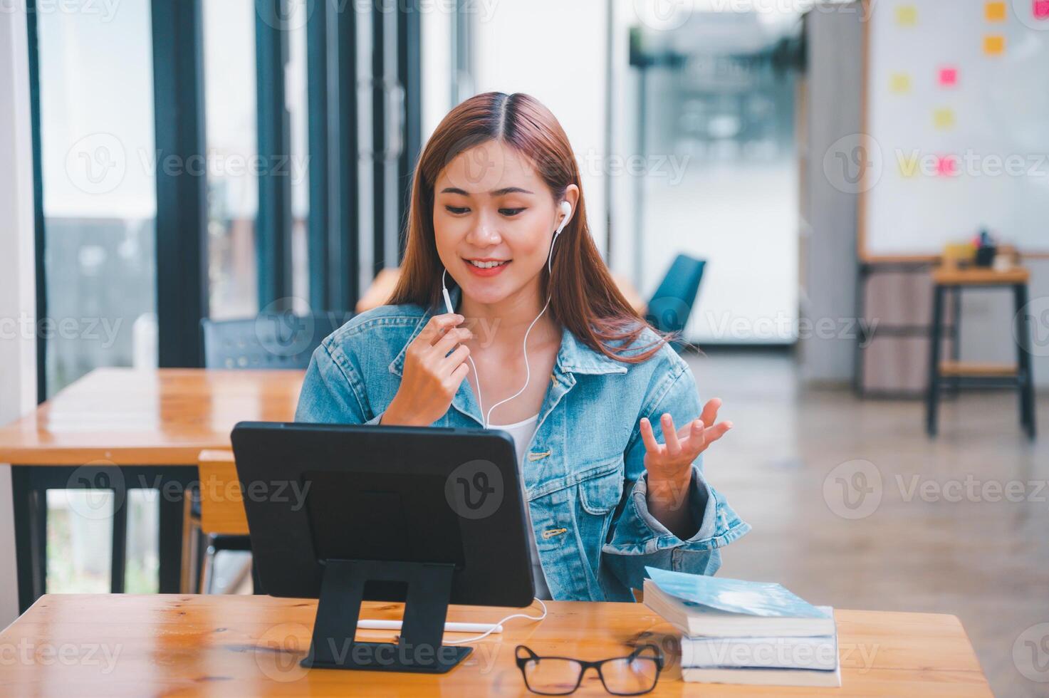 young student wearing small talk studies online, distance learning, and keeps up to date on the global coronavirus pandemic photo
