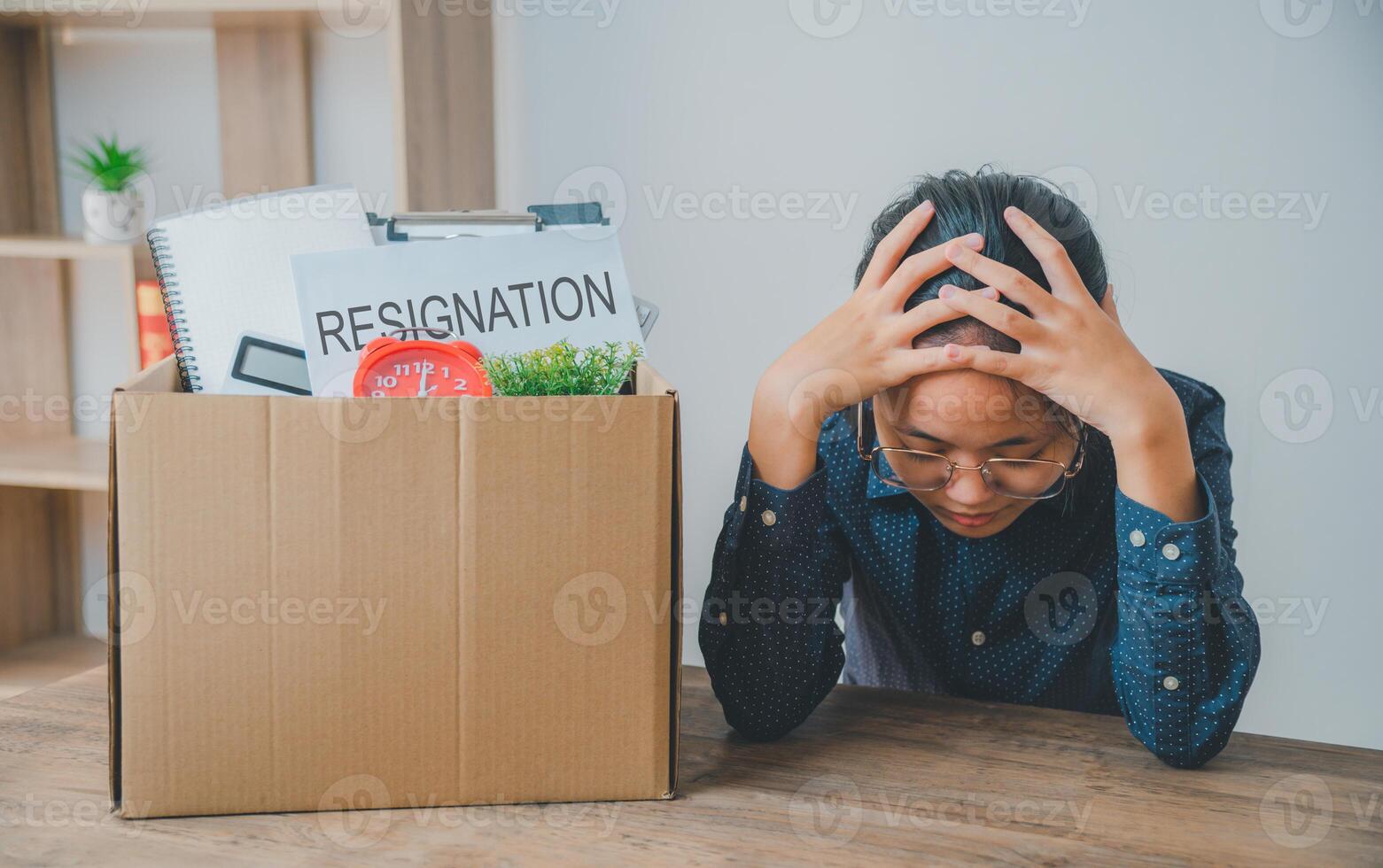 Female company employee stressed and fed up after quitting her job to look for a new job, fired or was fired by the employer photo