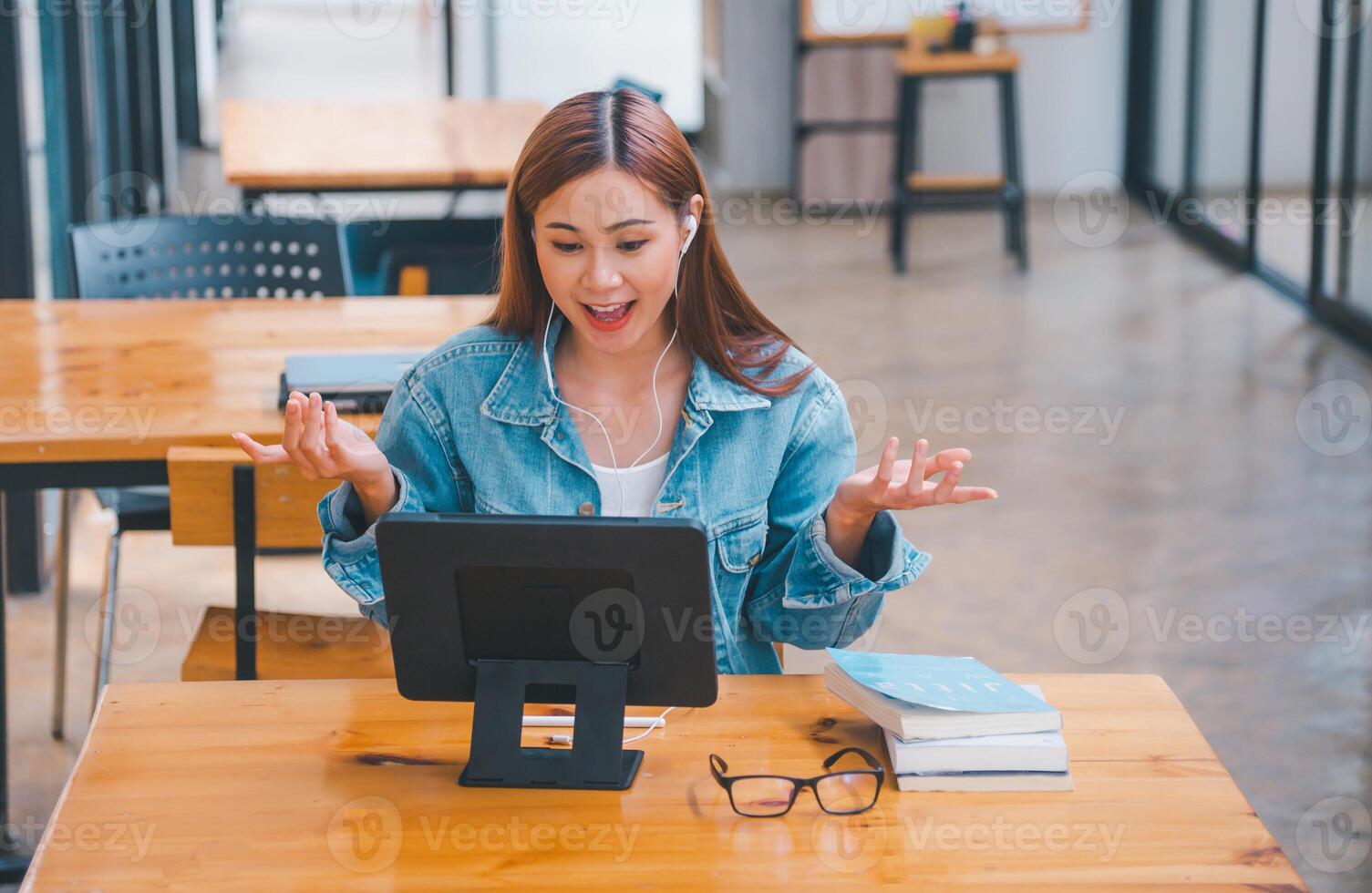 young student wearing small talk studies online, distance learning, and keeps up to date on the global coronavirus pandemic photo