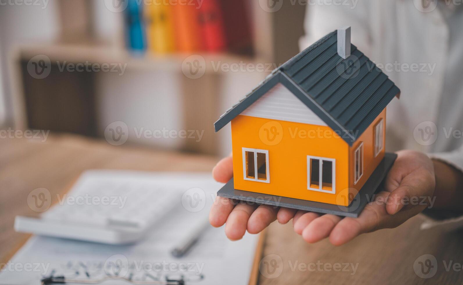 Salesperson Holding house keys concept, house keys for new house, new house purchase. photo
