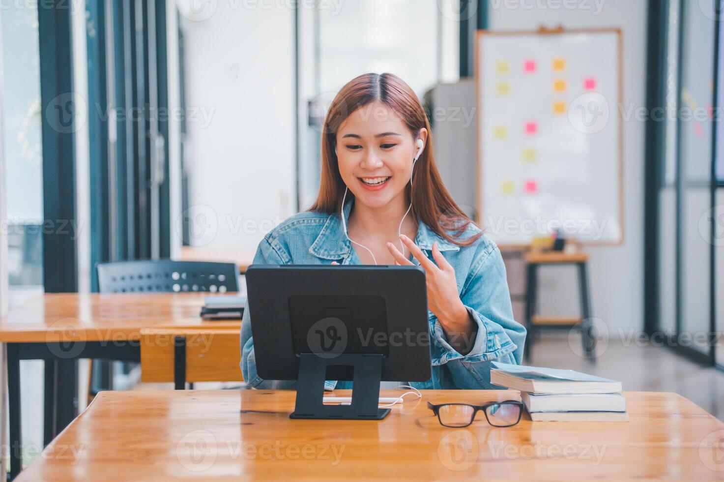 young student wearing small talk studies online, distance learning, and keeps up to date on the global coronavirus pandemic photo