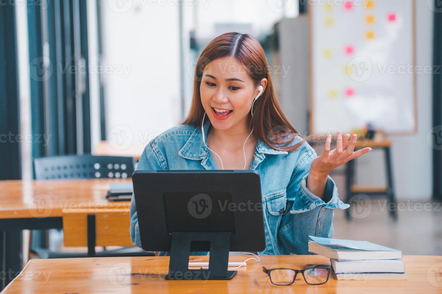 young student wearing small talk studies online, distance learning, and keeps up to date on the global coronavirus pandemic photo