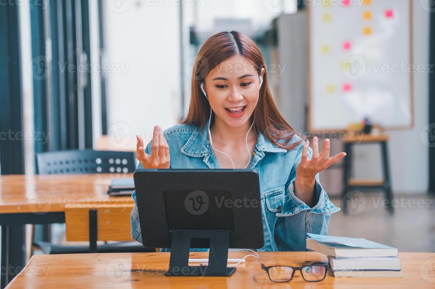 young student wearing small talk studies online, distance learning, and keeps up to date on the global coronavirus pandemic photo