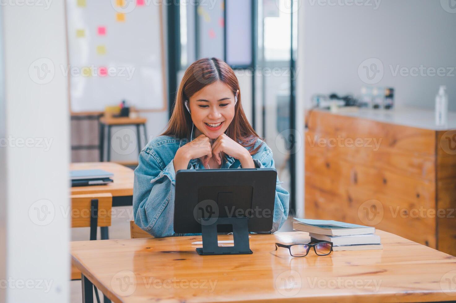 young student wearing small talk studies online, distance learning, and keeps up to date on the global coronavirus pandemic photo
