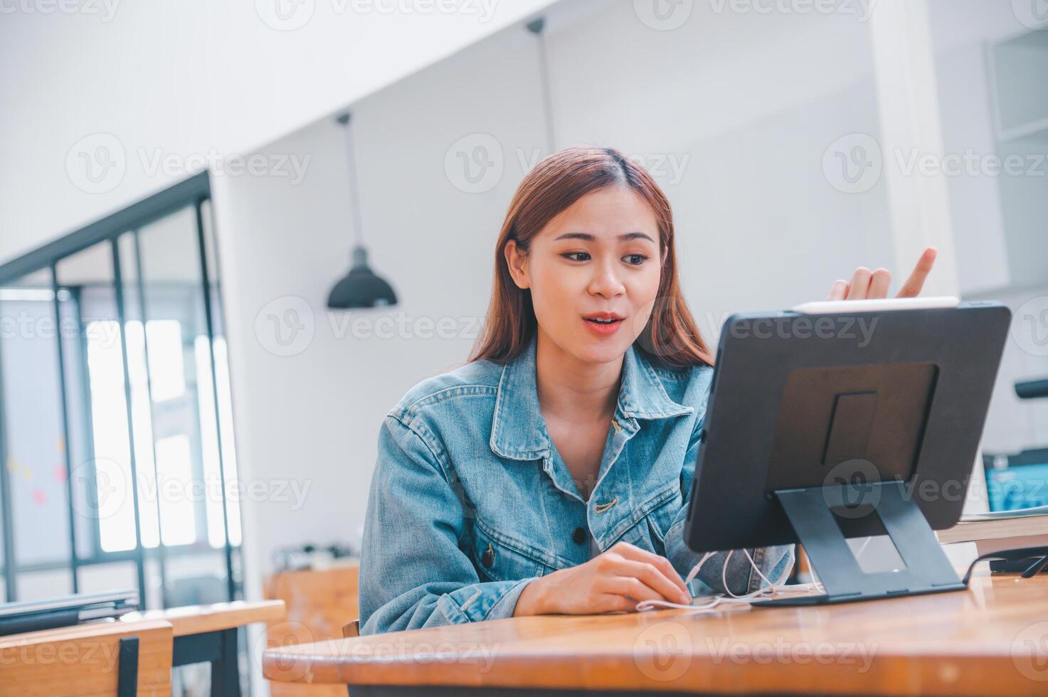 young student wearing small talk studies online, distance learning, and keeps up to date on the global coronavirus pandemic photo