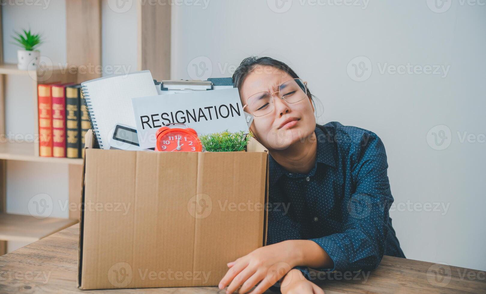 Female company employee stressed and fed up after quitting her job to look for a new job, fired or was fired by the employer photo
