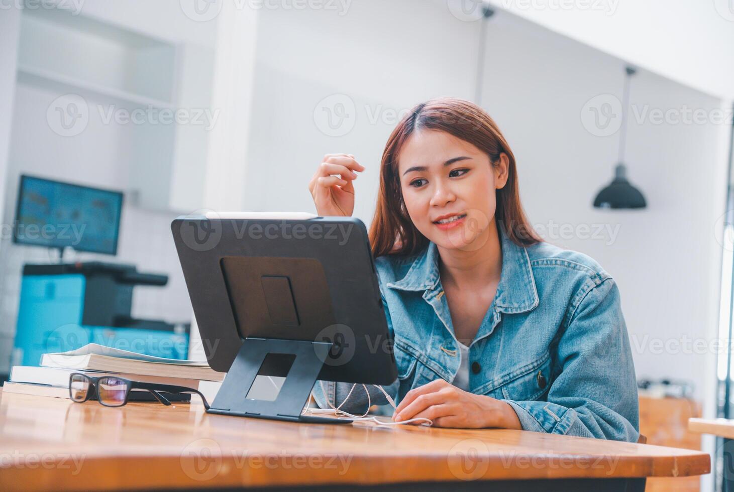young student wearing small talk studies online, distance learning, and keeps up to date on the global coronavirus pandemic photo