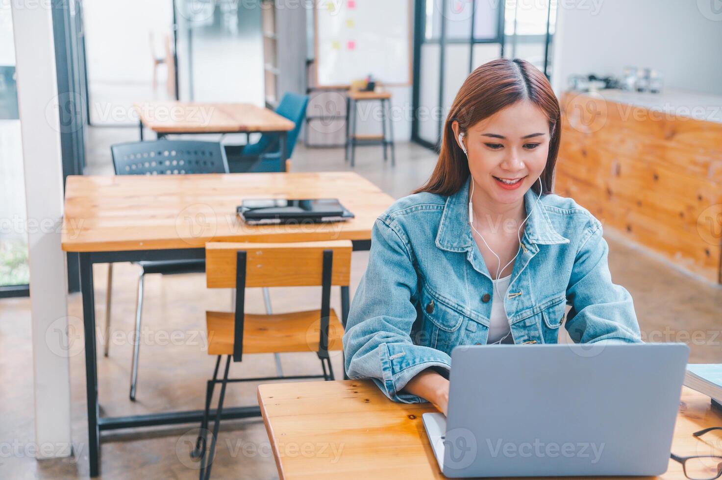 young student wearing small talk studies online, distance learning, and keeps up to date on the global coronavirus pandemic photo