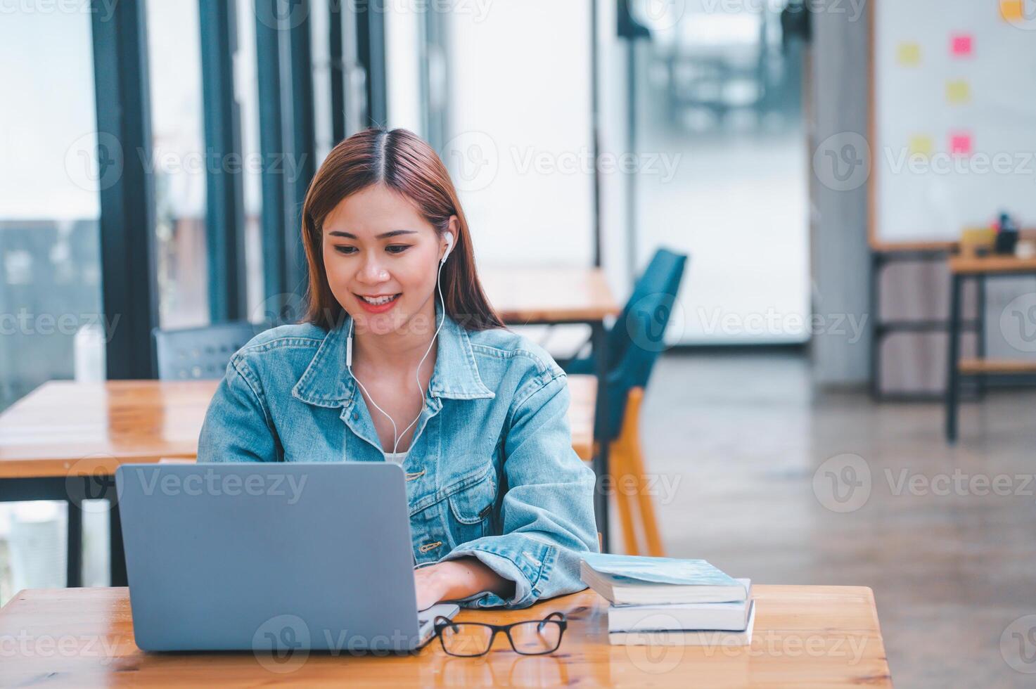 young student wearing small talk studies online, distance learning, and keeps up to date on the global coronavirus pandemic photo