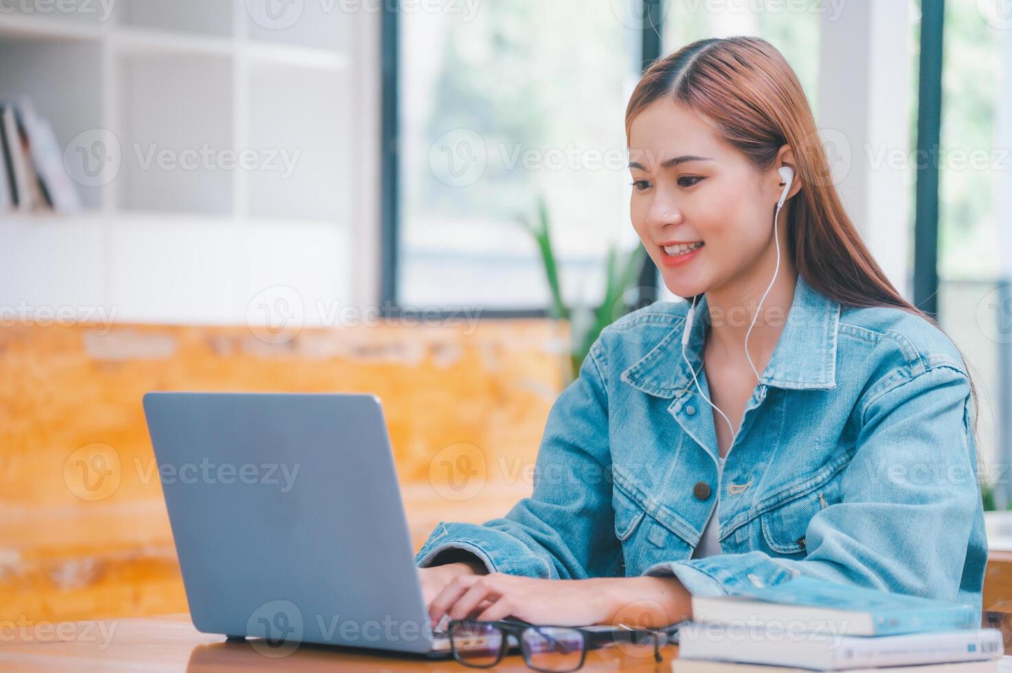 young student wearing small talk studies online, distance learning, and keeps up to date on the global coronavirus pandemic photo