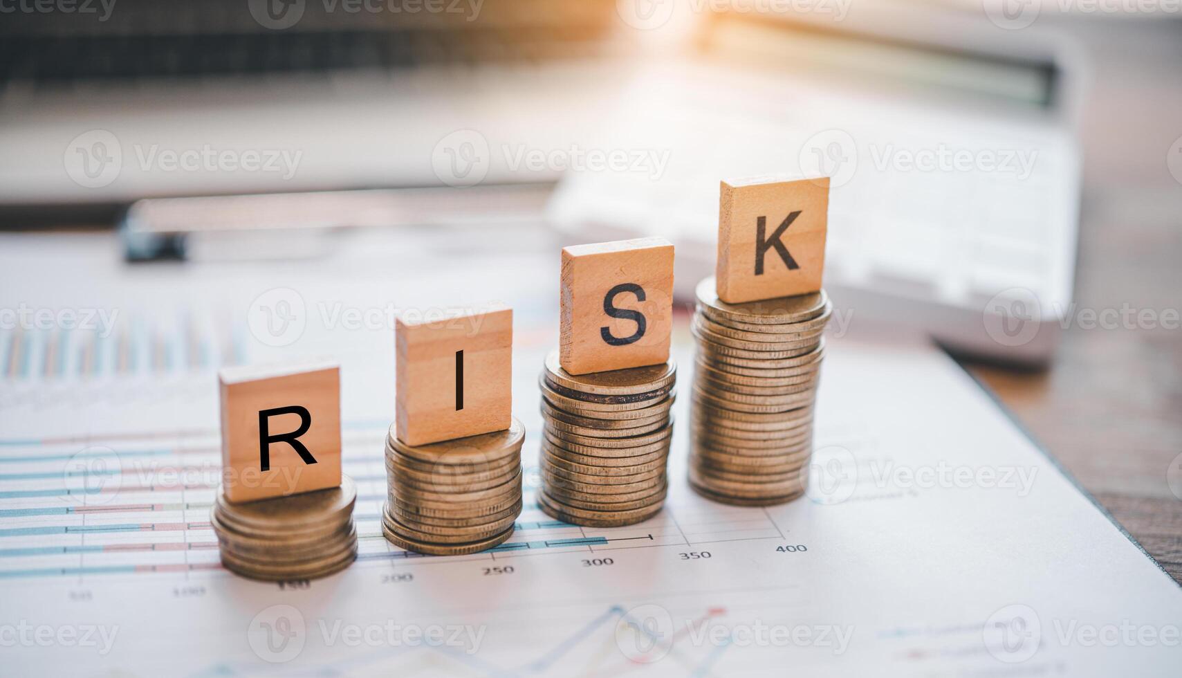 wooden block with the words RISK on silver coin.concept the goal of collecting money. Risk protection concept,Eliminating the risk. photo