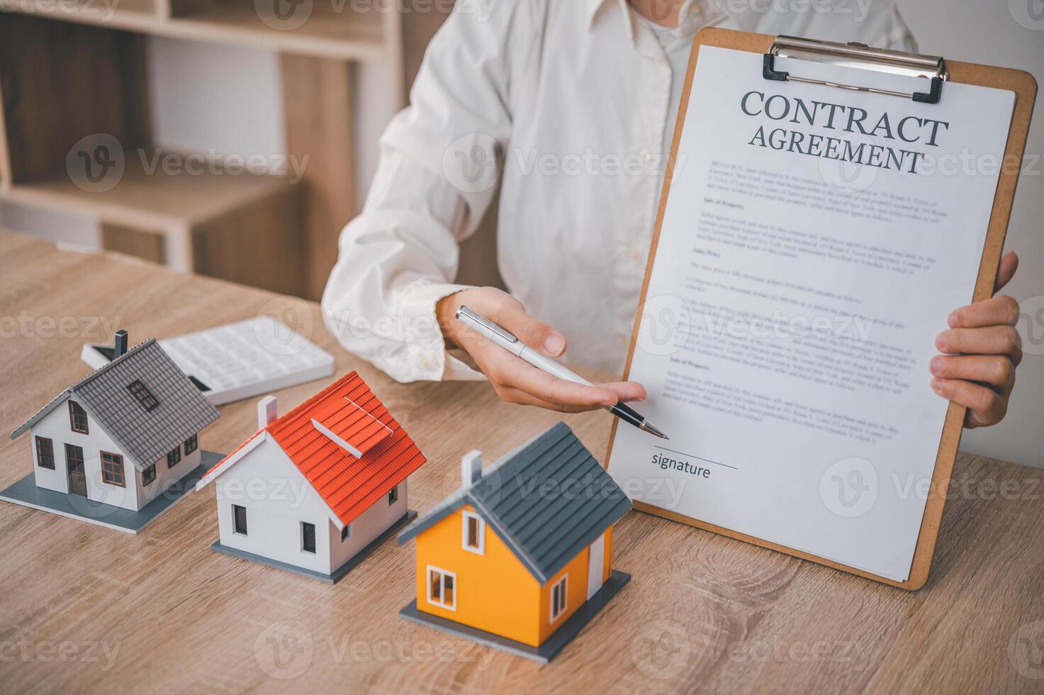 Salesperson Holding house keys concept, house keys for new house, new house purchase. photo