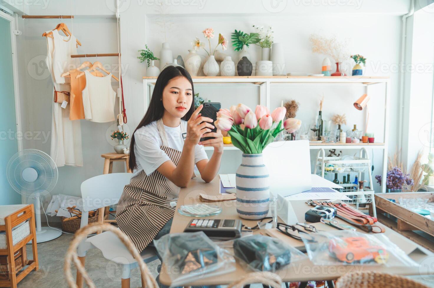 Small business owners are taking pictures of products to send to customers who will shop and take orders that customers order from an online retailer - online shopping. photo
