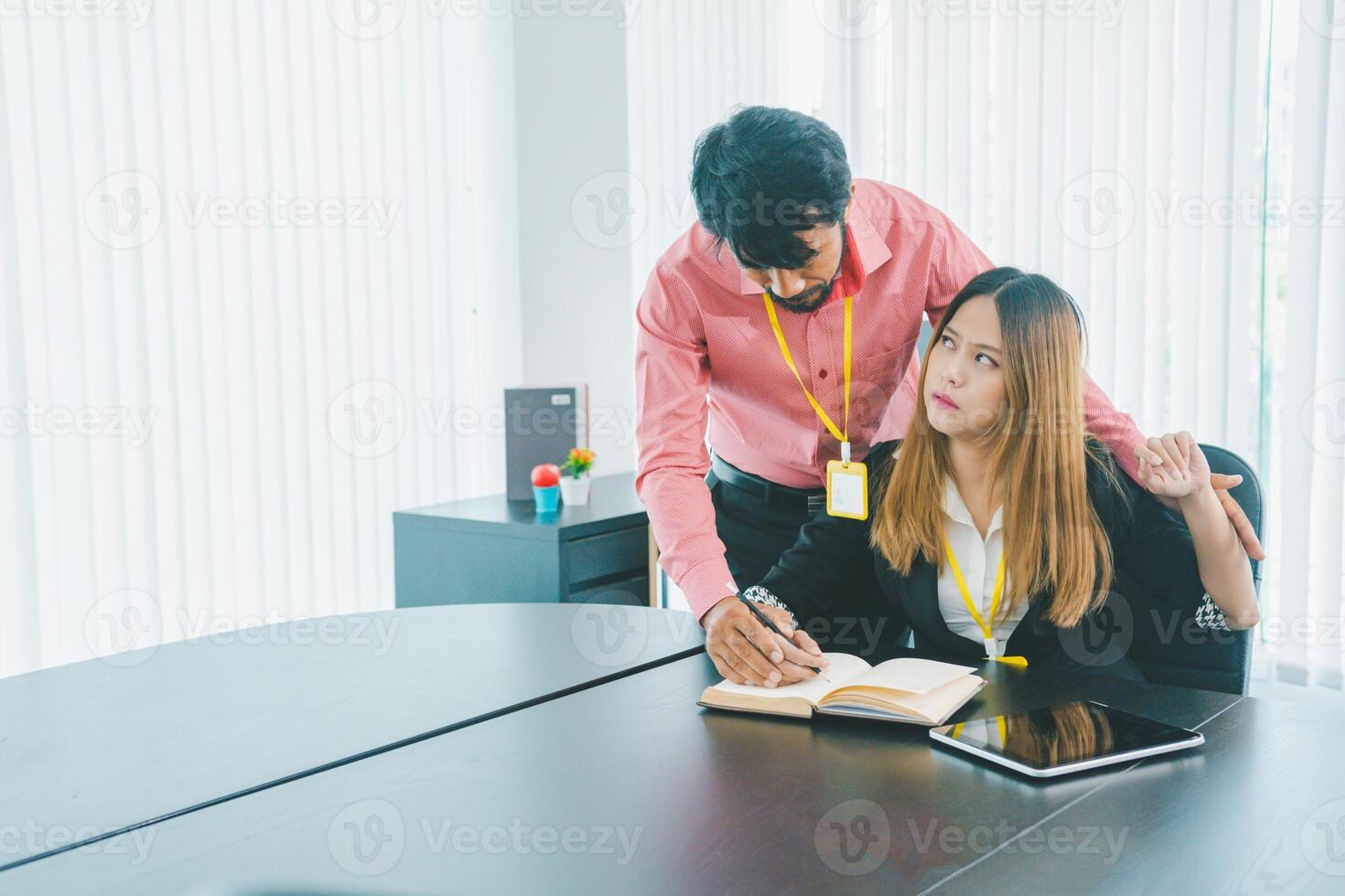 Boss or supervisor touching female employee's shoulder Causing young employees to resist because they are uncomfortable and afraid of being sexually abused. photo