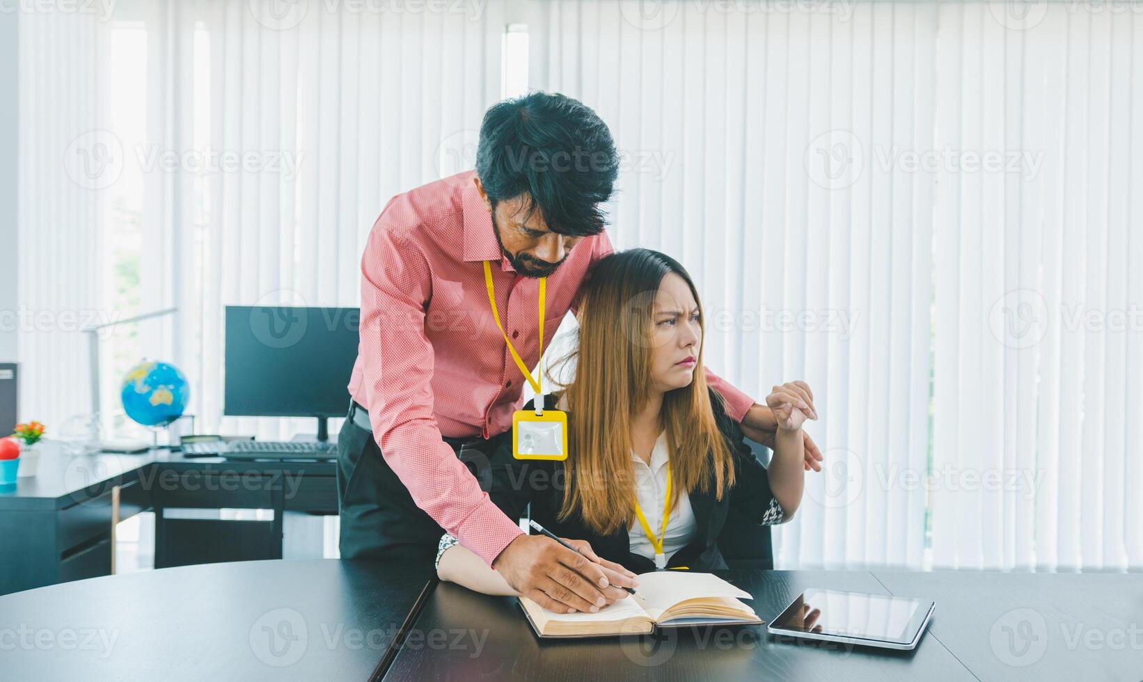 Boss or supervisor touching female employee's shoulder Causing young employees to resist because they are uncomfortable and afraid of being sexually abused photo