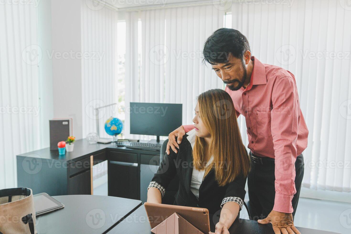 Boss or supervisor touching female employee's shoulder Causing young employees to resist because they are uncomfortable and afraid of being sexually abused photo