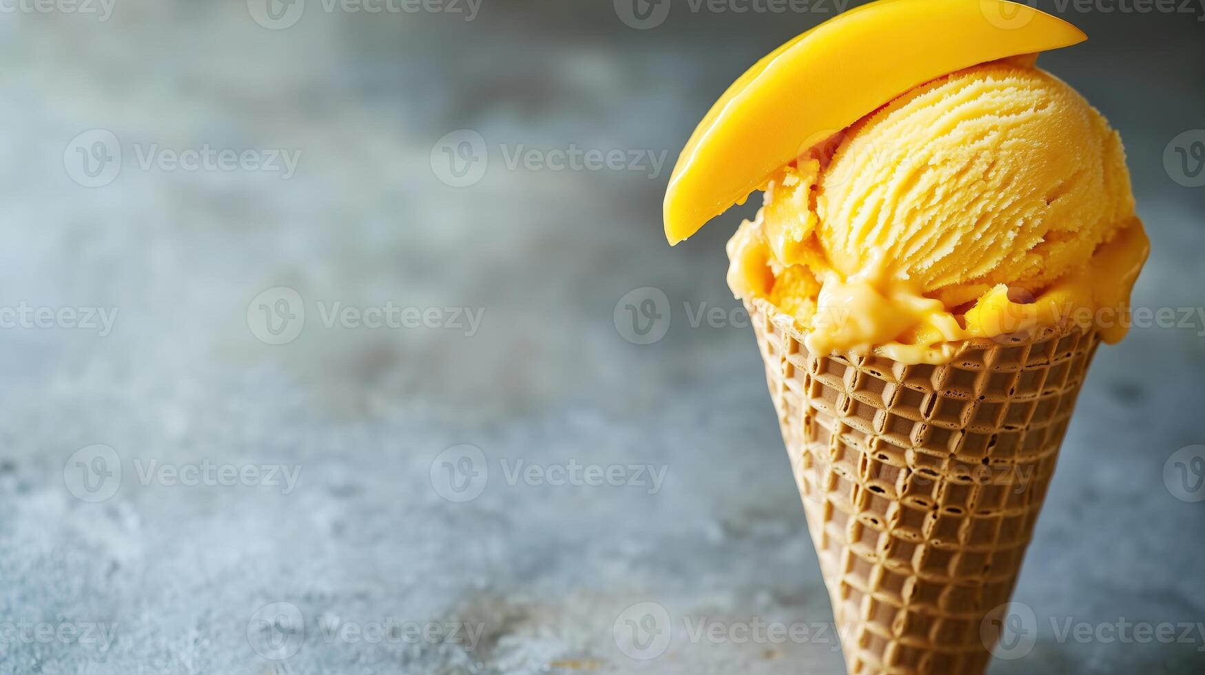 A mango ice cream cone with a slice of mango on top photo