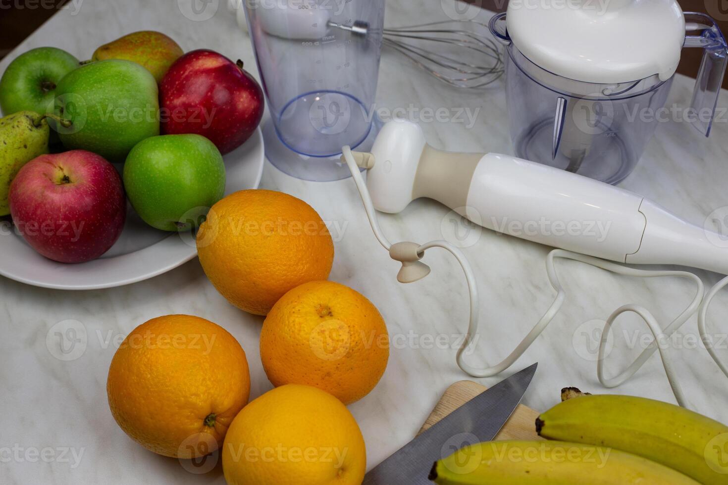 Table with fruits and blender for making smoothies and sports drinks. Ingredients for healthy fruit cocktail for health and immunity at home photo
