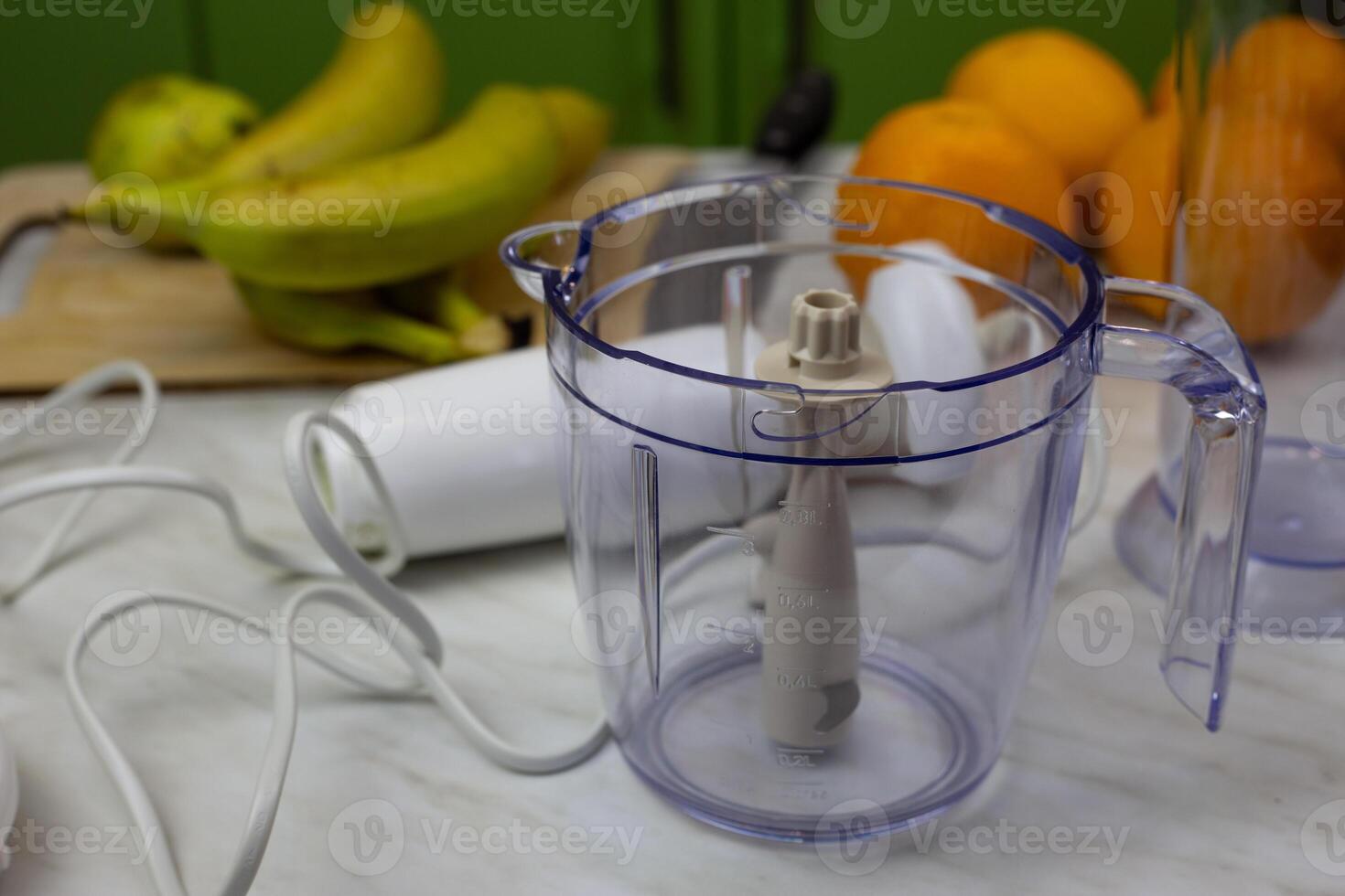 Container with blades and blender on background of fruits for chopping and making healthy drink photo