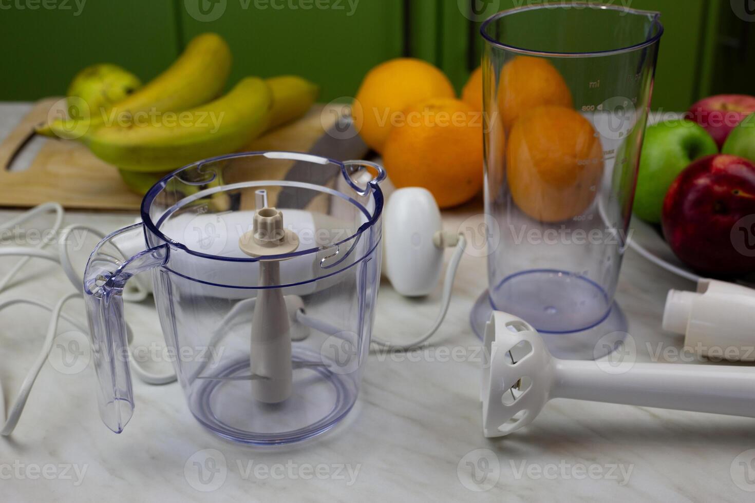 Disassembled blender and fruits on the table for making tasty drink with vitamins. Strengthening health with fruits and sports cocktails. Making smoothies in blender photo