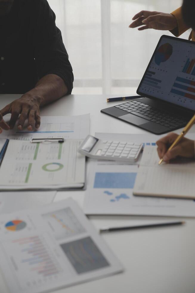 Close up of Business team analyzing income charts and graphs with modern laptop computer. Business analysis and strategy concept. photo