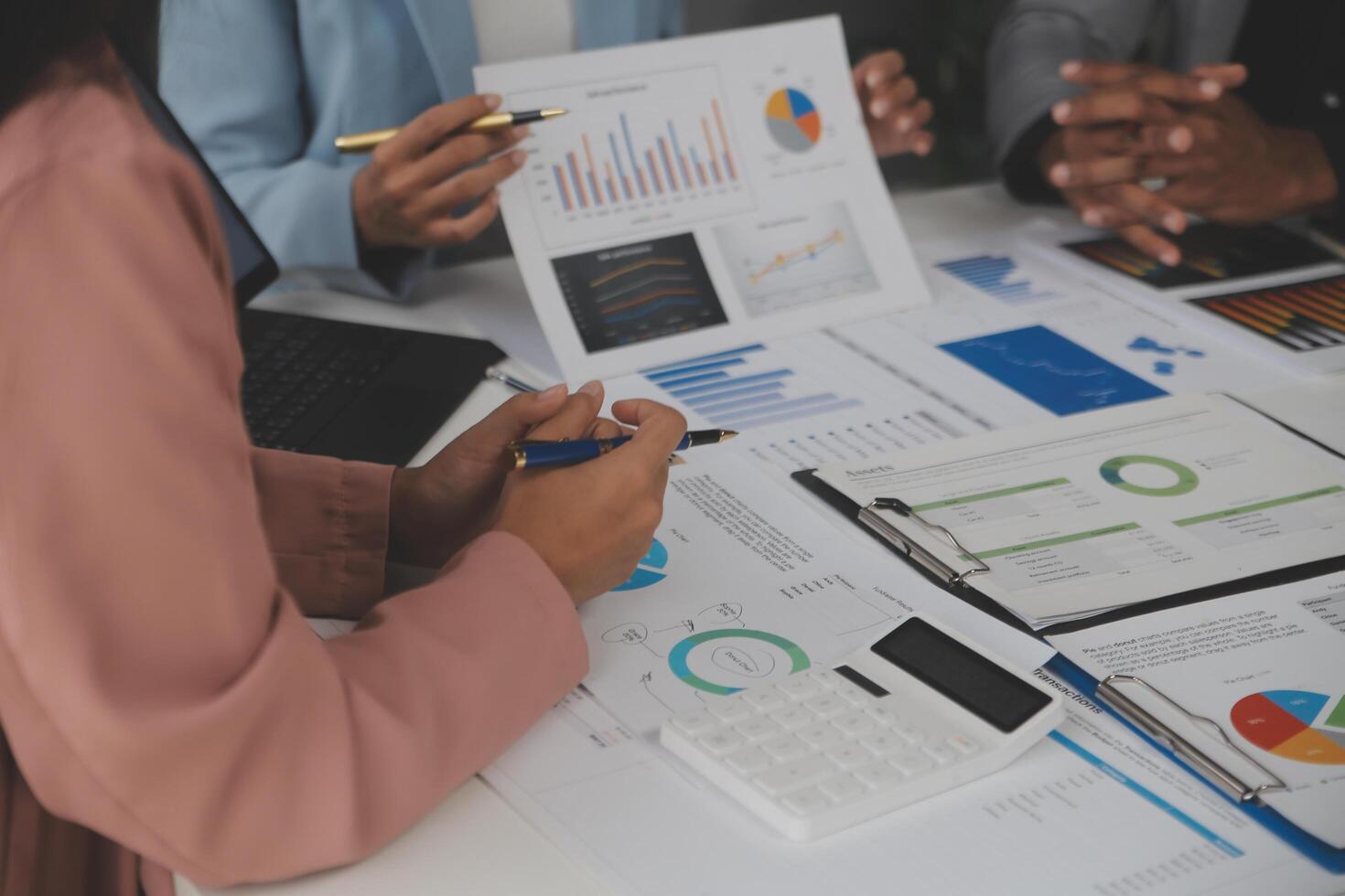 Close up of Business team analyzing income charts and graphs with modern laptop computer. Business analysis and strategy concept. photo