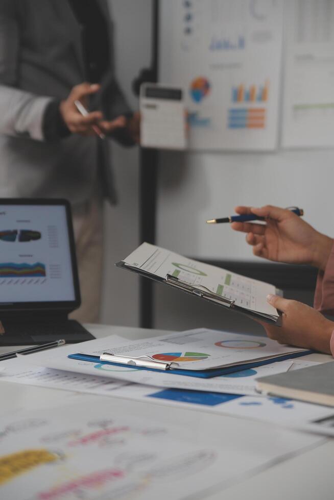 Close up of Business team analyzing income charts and graphs with modern laptop computer. Business analysis and strategy concept. photo