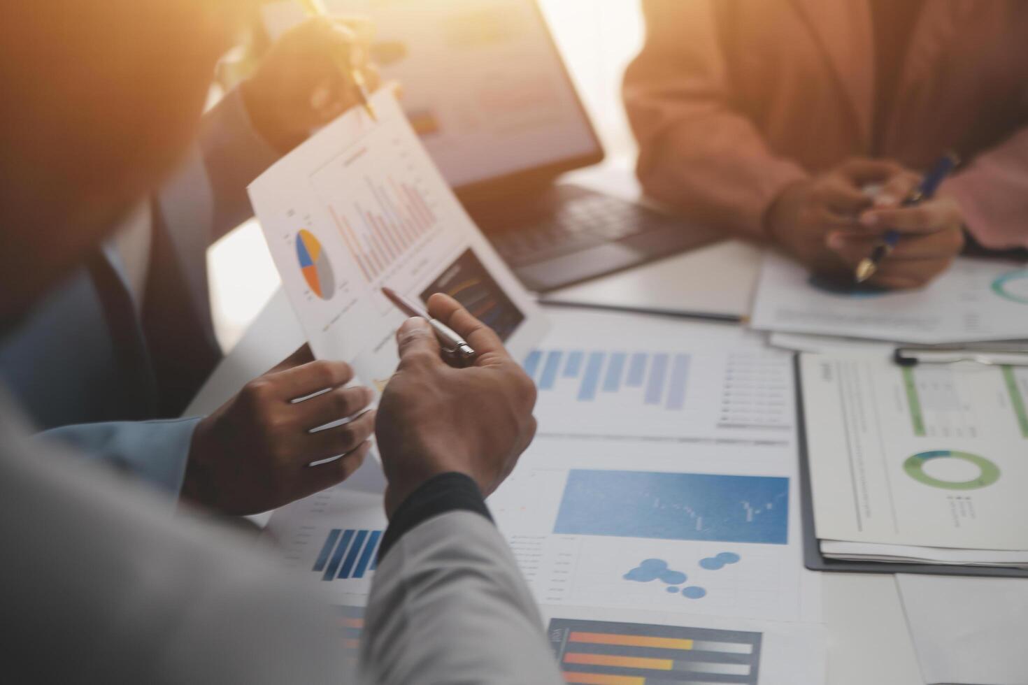 Close up of Business team analyzing income charts and graphs with modern laptop computer. Business analysis and strategy concept. photo