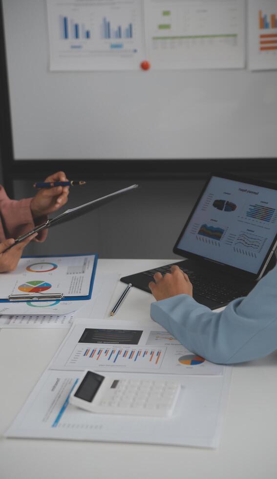 Close up of Business team analyzing income charts and graphs with modern laptop computer. Business analysis and strategy concept. photo