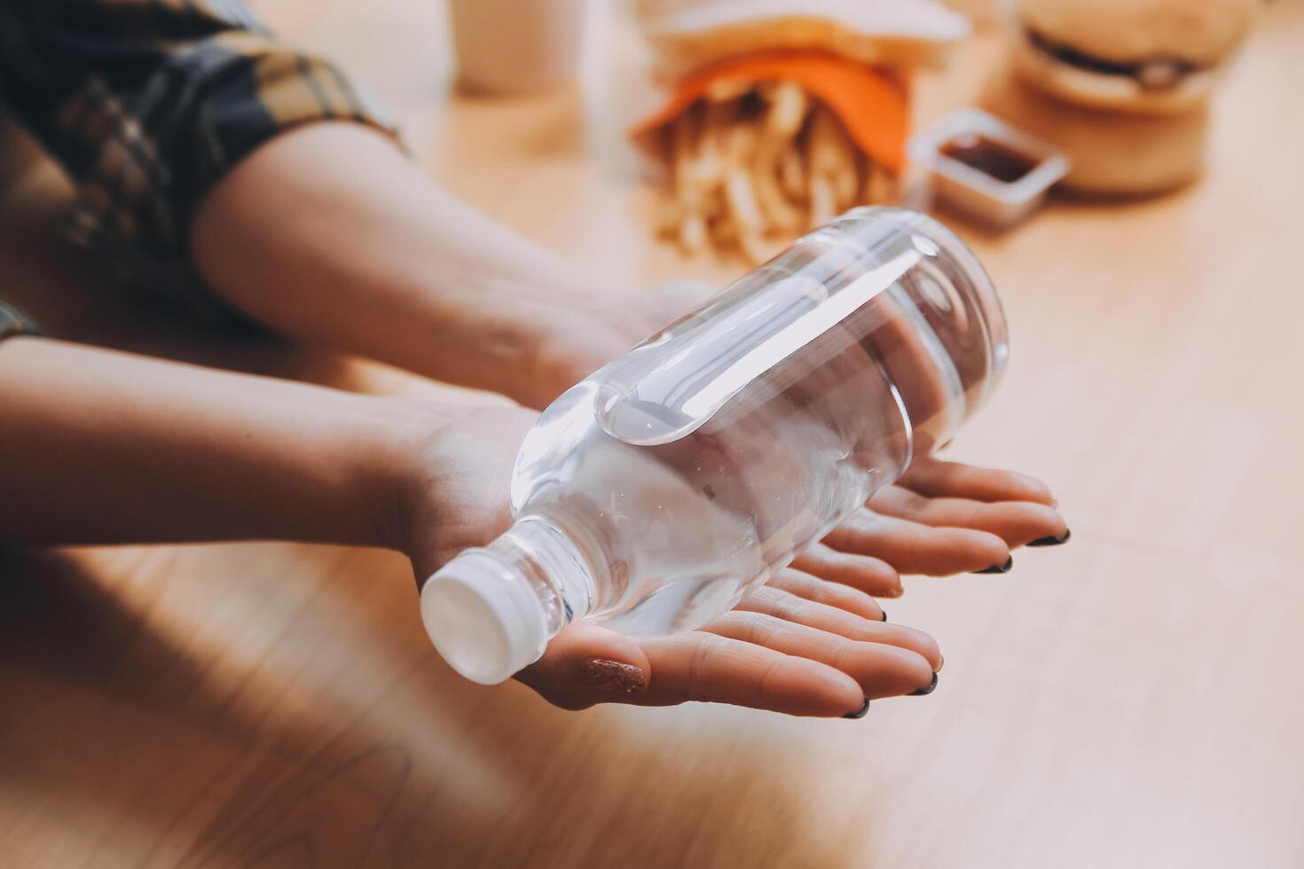 healthy beautiful young woman holding glass of water photo