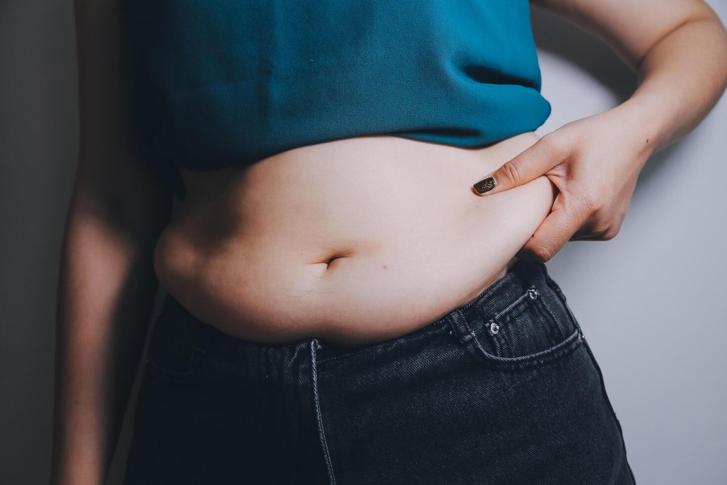 fat woman, fat belly, chubby, obese woman hand holding excessive belly fat with measure tape, woman diet lifestyle concept photo