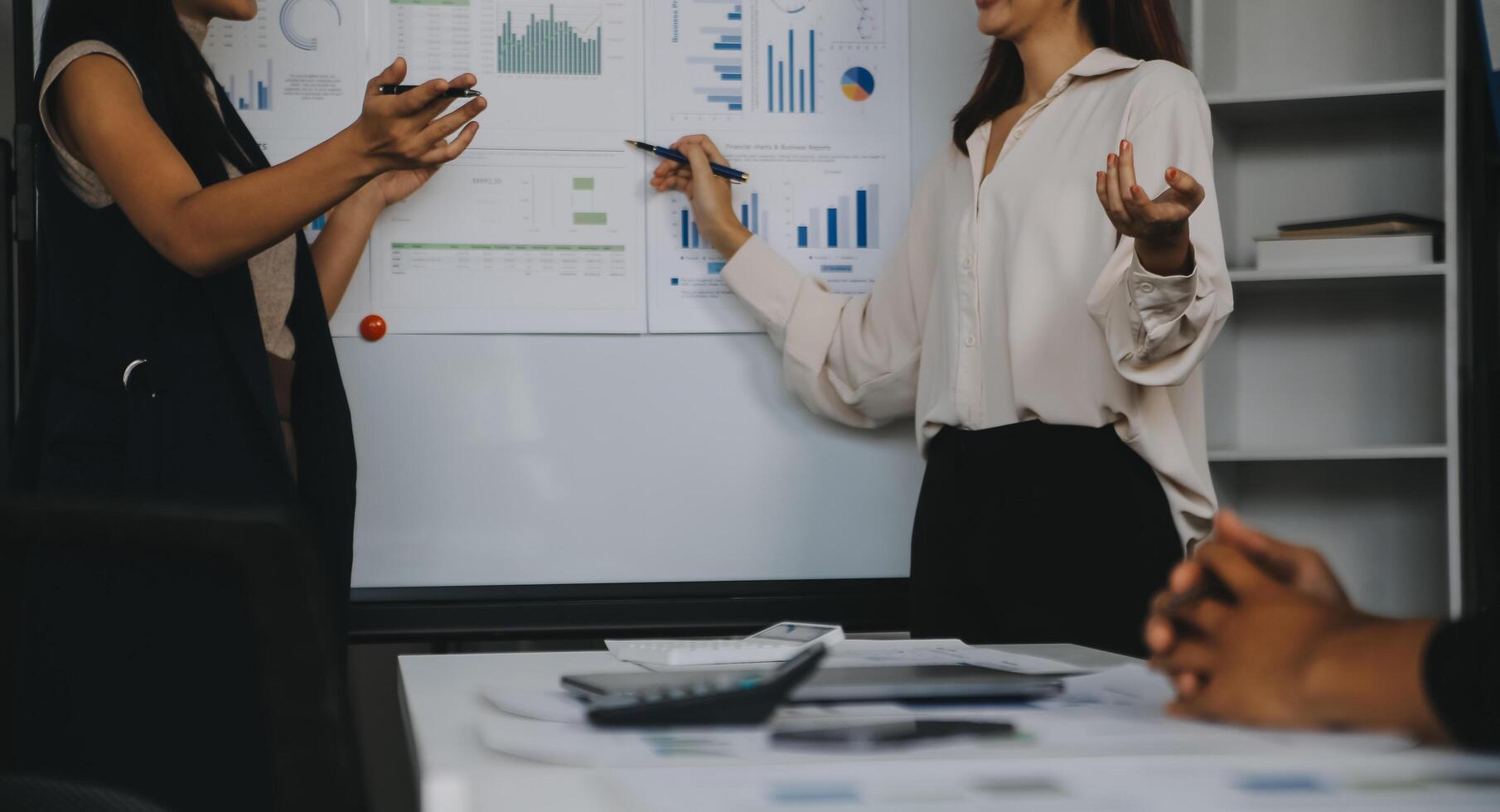Financial analysts analyze business financial reports on a digital tablet planning investment project during a discussion at a meeting of corporate showing the results of their successful teamwork. photo