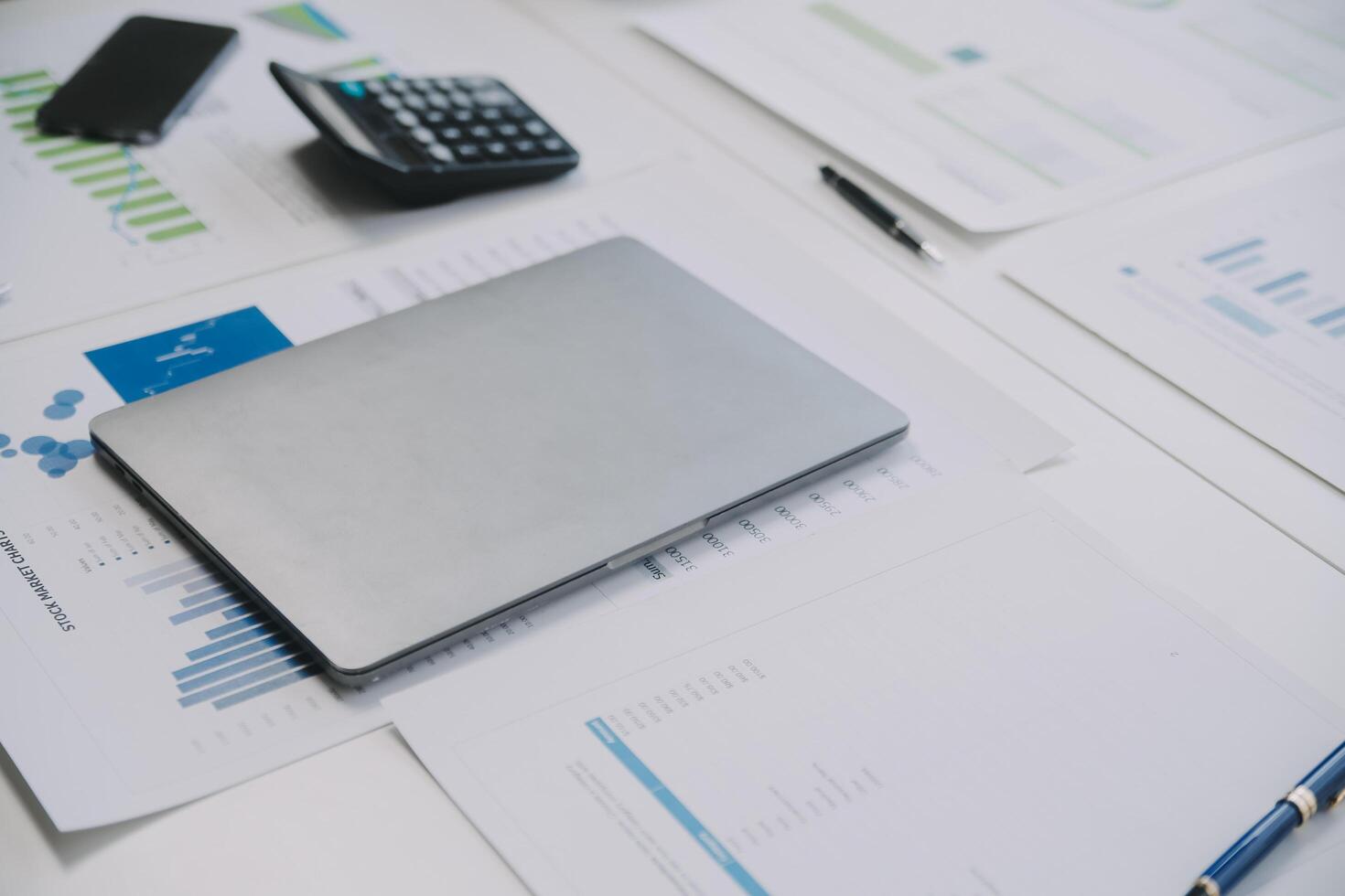 Financial analysts analyze business financial reports on a digital tablet planning investment project during a discussion at a meeting of corporate showing the results of their successful teamwork. photo