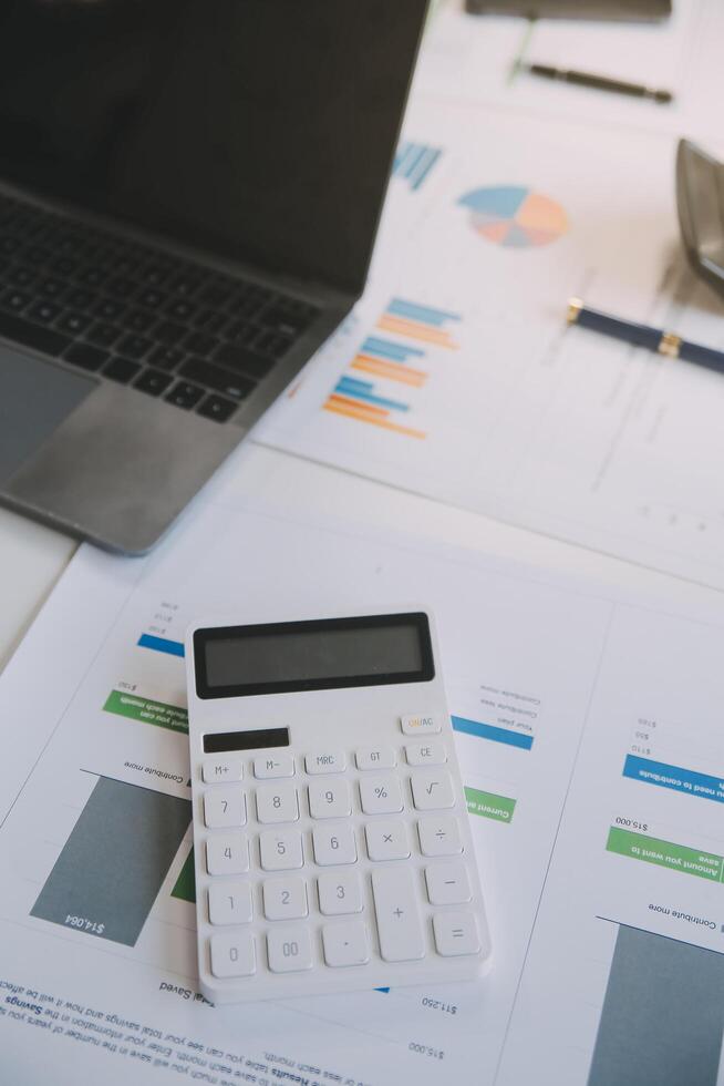 Financial analysts analyze business financial reports on a digital tablet planning investment project during a discussion at a meeting of corporate showing the results of their successful teamwork. photo