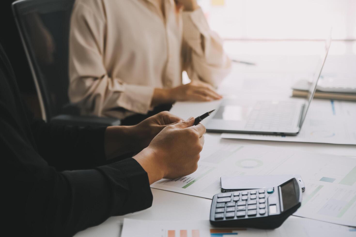 Financial analysts analyze business financial reports on a digital tablet planning investment project during a discussion at a meeting of corporate showing the results of their successful teamwork. photo