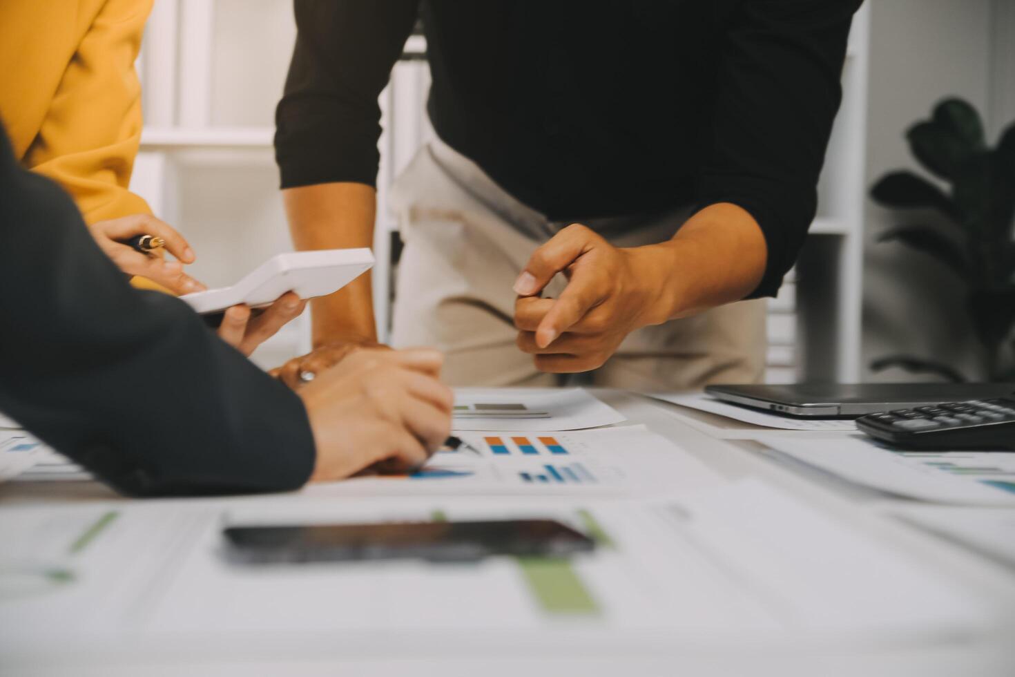 Financial analysts analyze business financial reports on a digital tablet planning investment project during a discussion at a meeting of corporate showing the results of their successful teamwork. photo