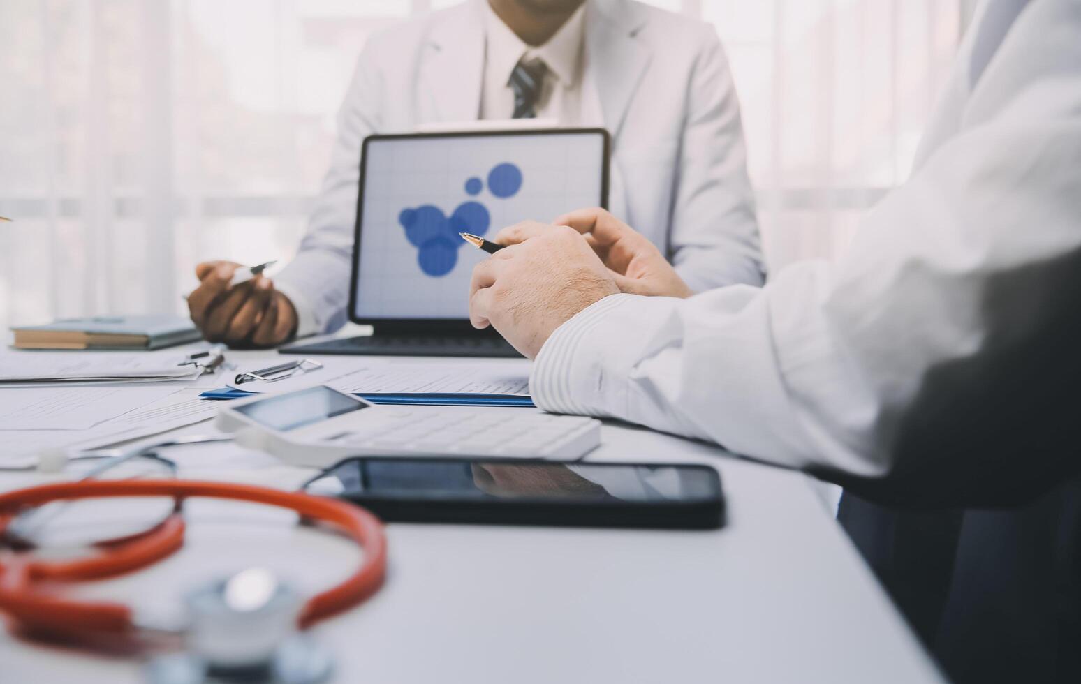 Meeting, tablet and team of doctors with collaboration for healthcare talk and telehealth app in office. Surgeon group, tech and medical discussion with website for hospital funding or sponsorship photo