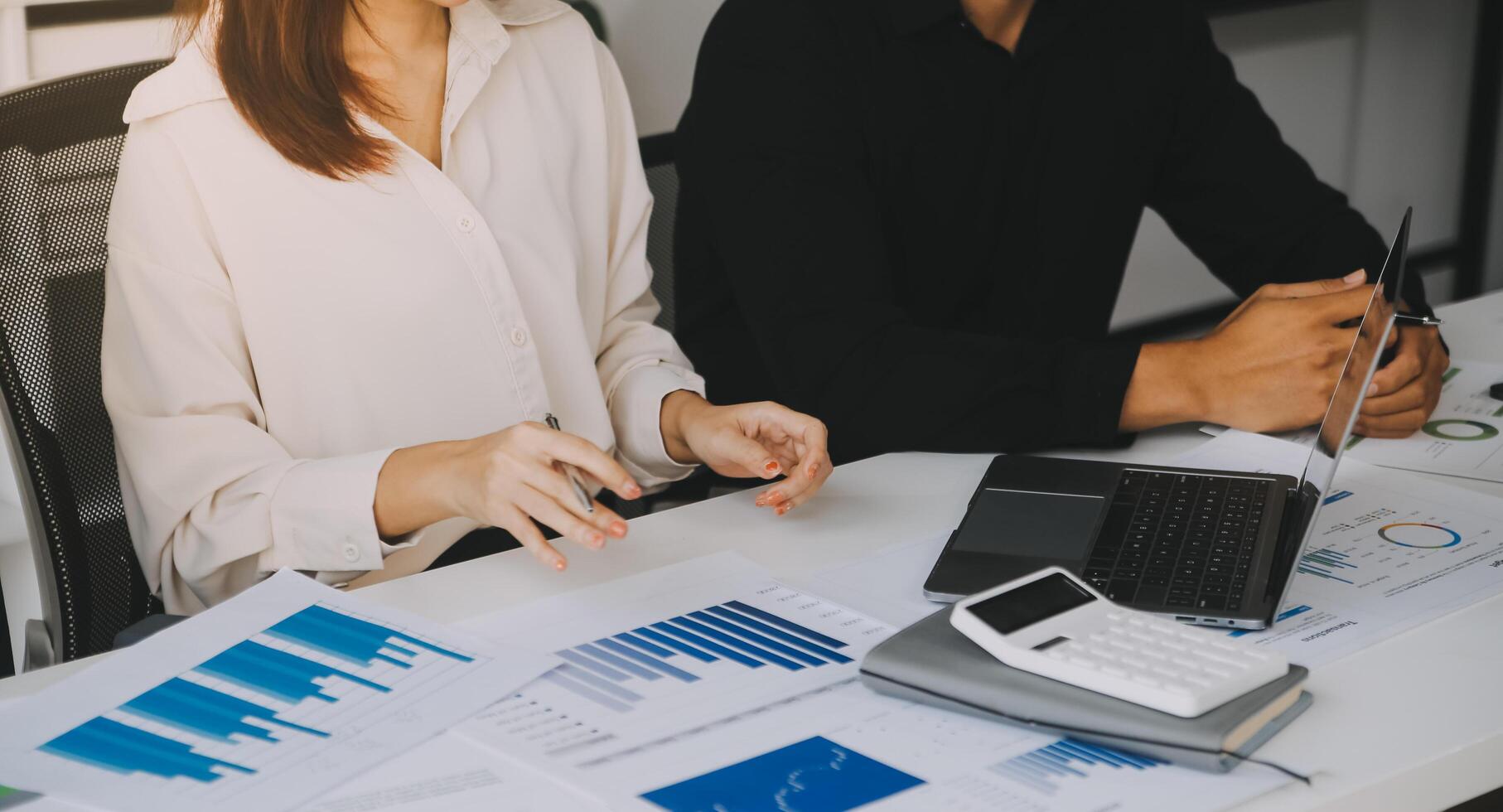 Financial analysts analyze business financial reports on a digital tablet planning investment project during a discussion at a meeting of corporate showing the results of their successful teamwork. photo