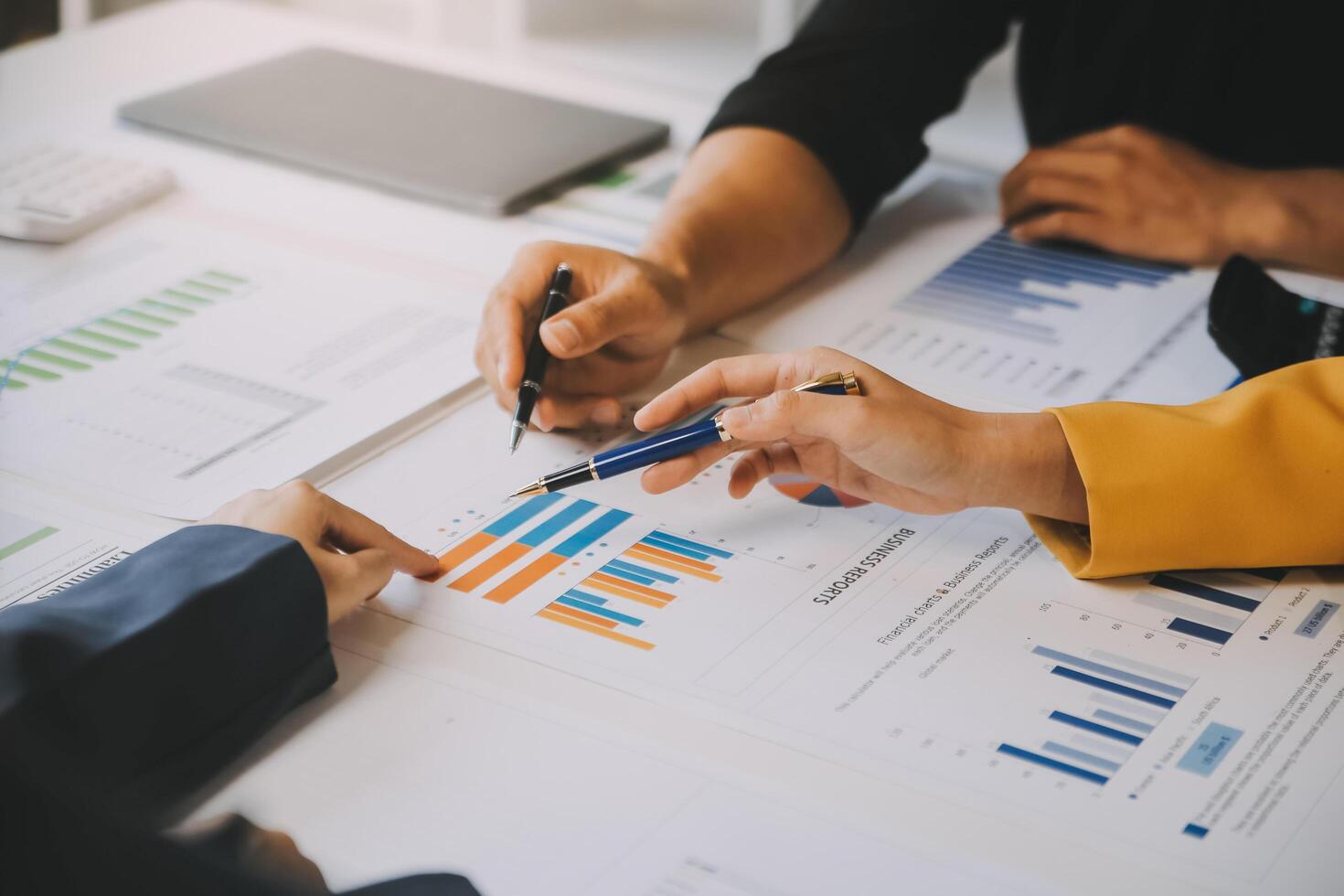 Financial analysts analyze business financial reports on a digital tablet planning investment project during a discussion at a meeting of corporate showing the results of their successful teamwork. photo