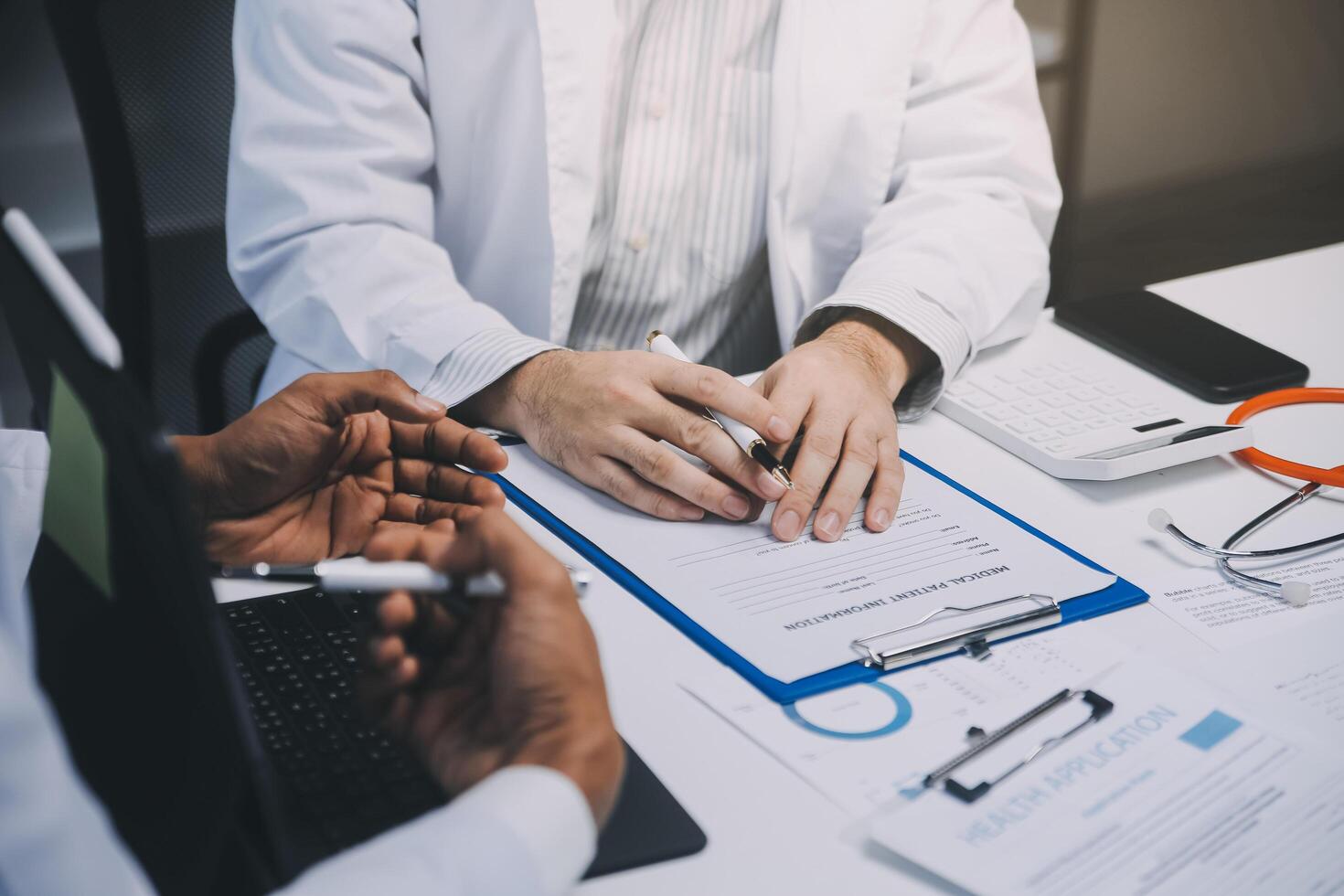 Meeting, tablet and team of doctors with collaboration for healthcare talk and telehealth app in office. Surgeon group, tech and medical discussion with website for hospital funding or sponsorship photo