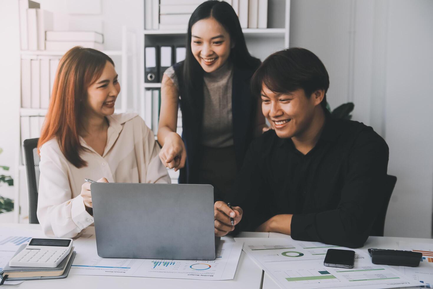 Financial analysts analyze business financial reports on a digital tablet planning investment project during a discussion at a meeting of corporate showing the results of their successful teamwork. photo