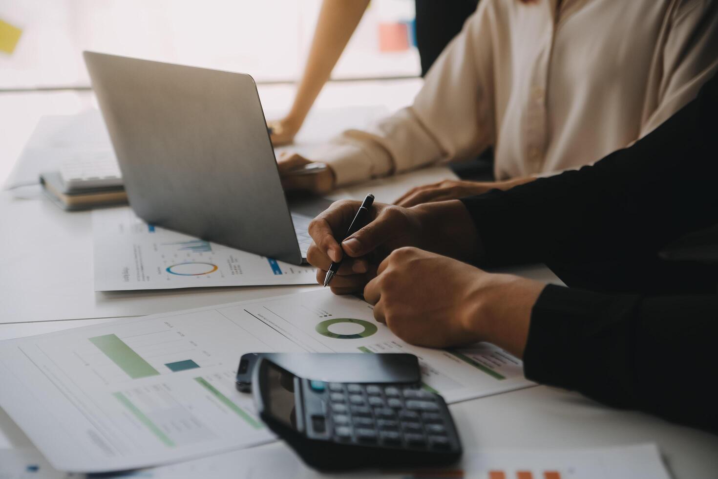 Financial analysts analyze business financial reports on a digital tablet planning investment project during a discussion at a meeting of corporate showing the results of their successful teamwork. photo