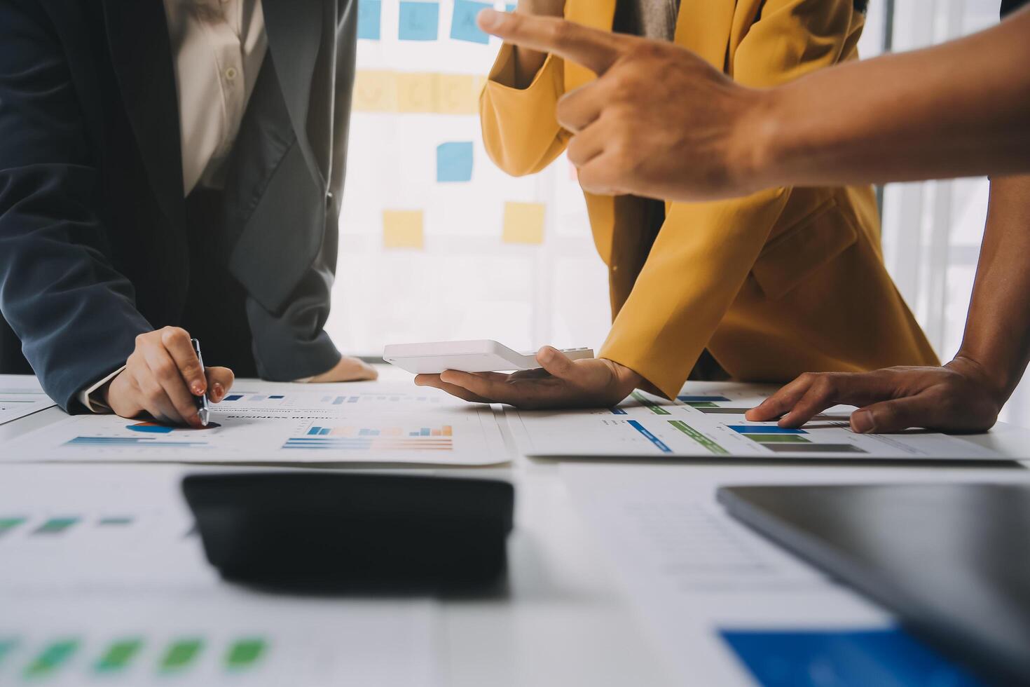 Financial analysts analyze business financial reports on a digital tablet planning investment project during a discussion at a meeting of corporate showing the results of their successful teamwork. photo