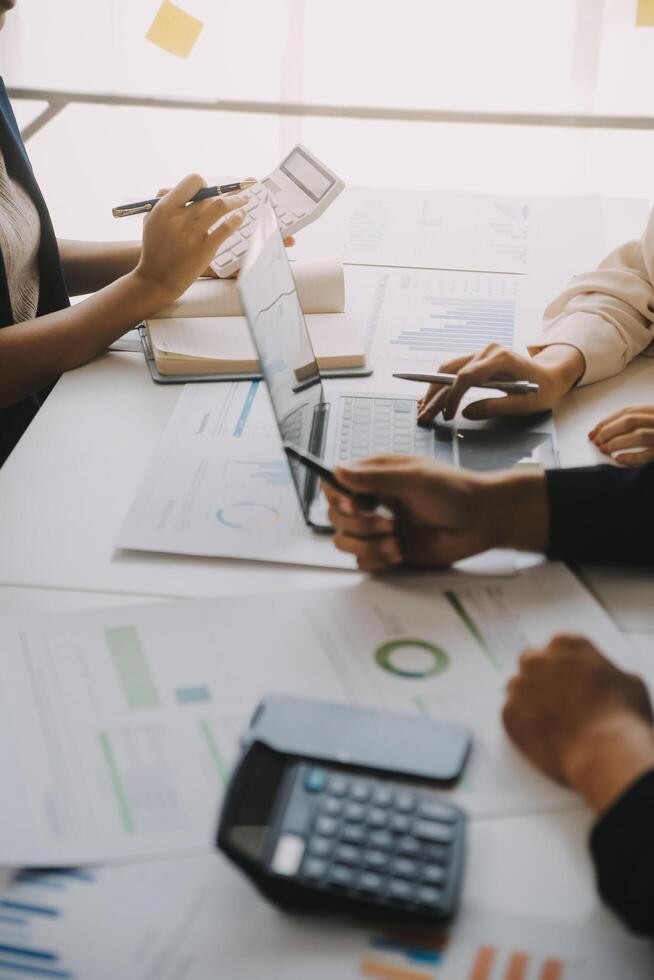 Financial analysts analyze business financial reports on a digital tablet planning investment project during a discussion at a meeting of corporate showing the results of their successful teamwork. photo