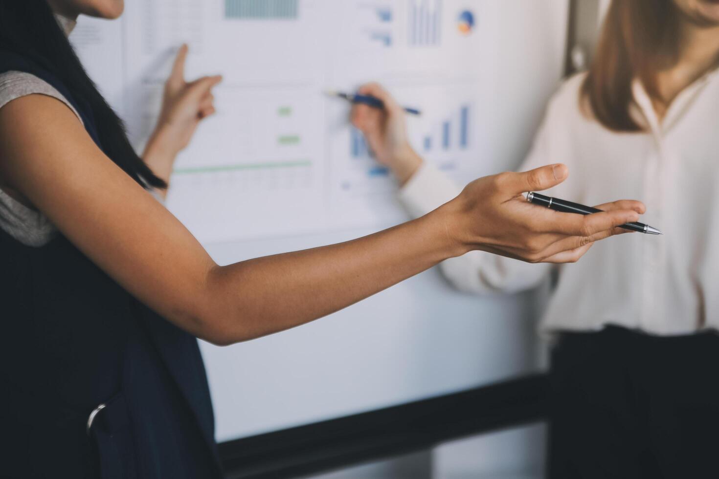 Financial analysts analyze business financial reports on a digital tablet planning investment project during a discussion at a meeting of corporate showing the results of their successful teamwork. photo
