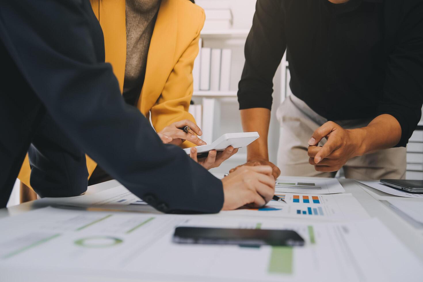 Financial analysts analyze business financial reports on a digital tablet planning investment project during a discussion at a meeting of corporate showing the results of their successful teamwork. photo